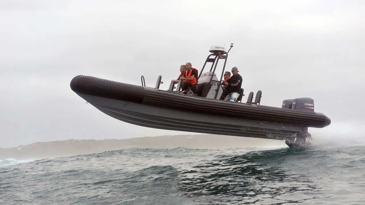 Side view of an inflatable boat planing