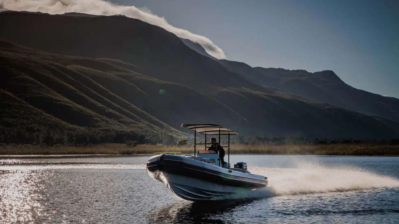 Frontal view of a speeding inflatable boat with its bow high out of the water