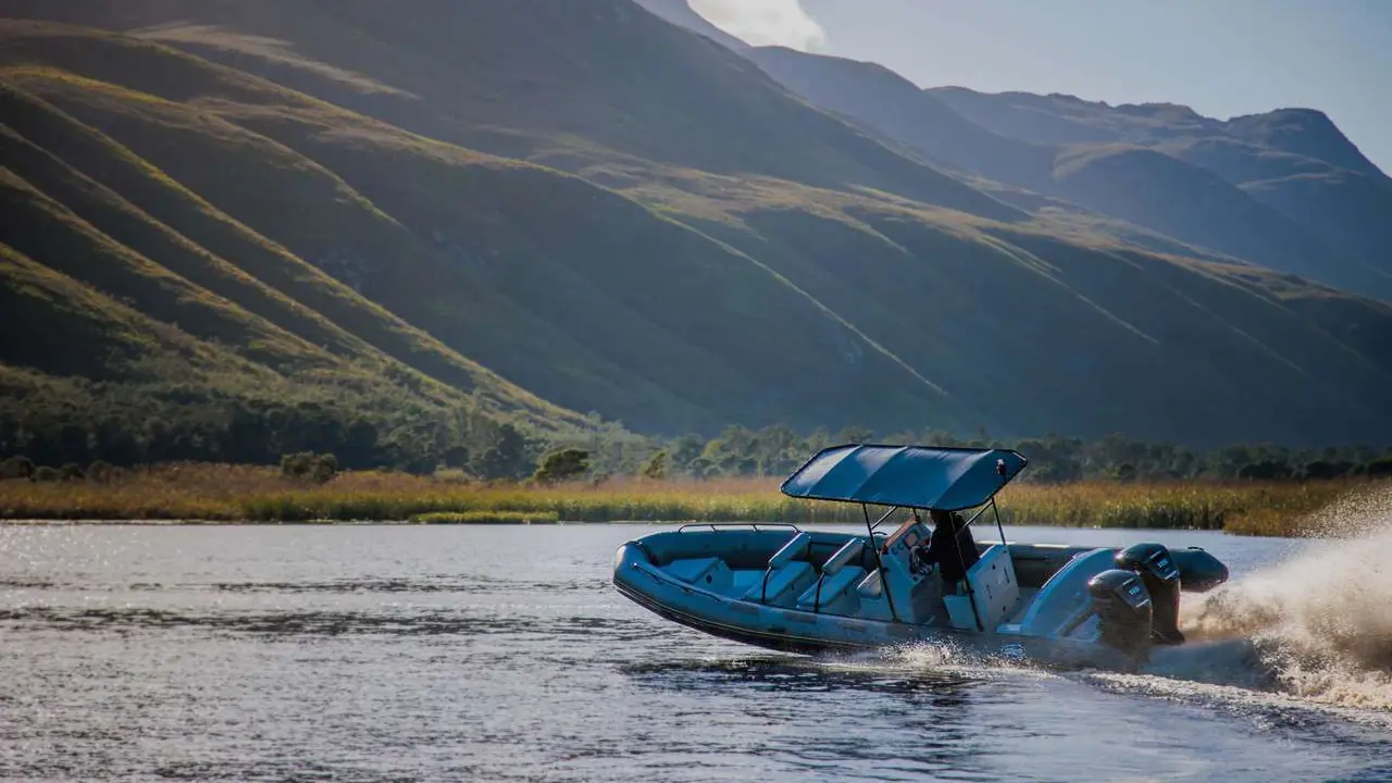 Side view of an inflatable boat taking a sharp left turn