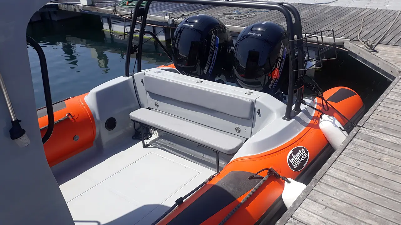 Stern of inflatable with twin black outboards