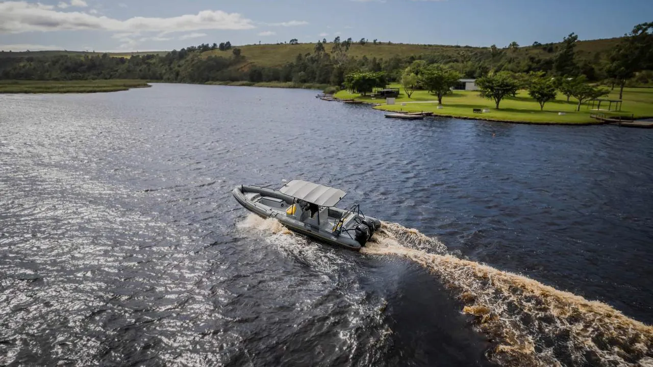 Wake behind inflatable boat on dam water