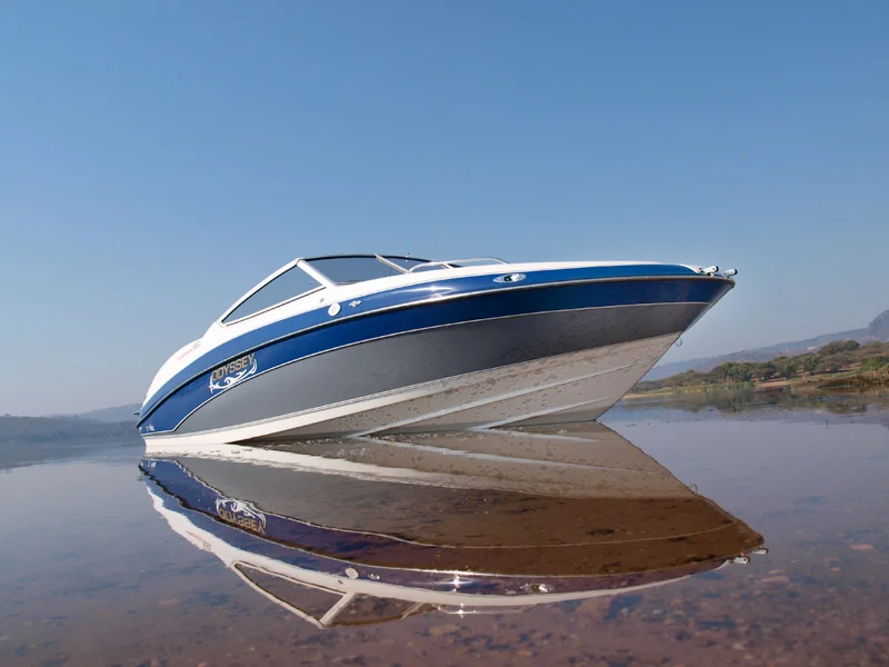 Navy and blue boat on mirror-smooth water
