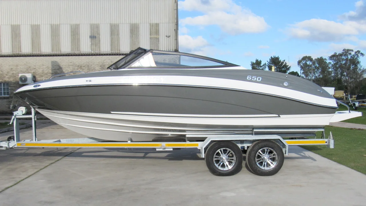 Grey and white boat on double axle trailer