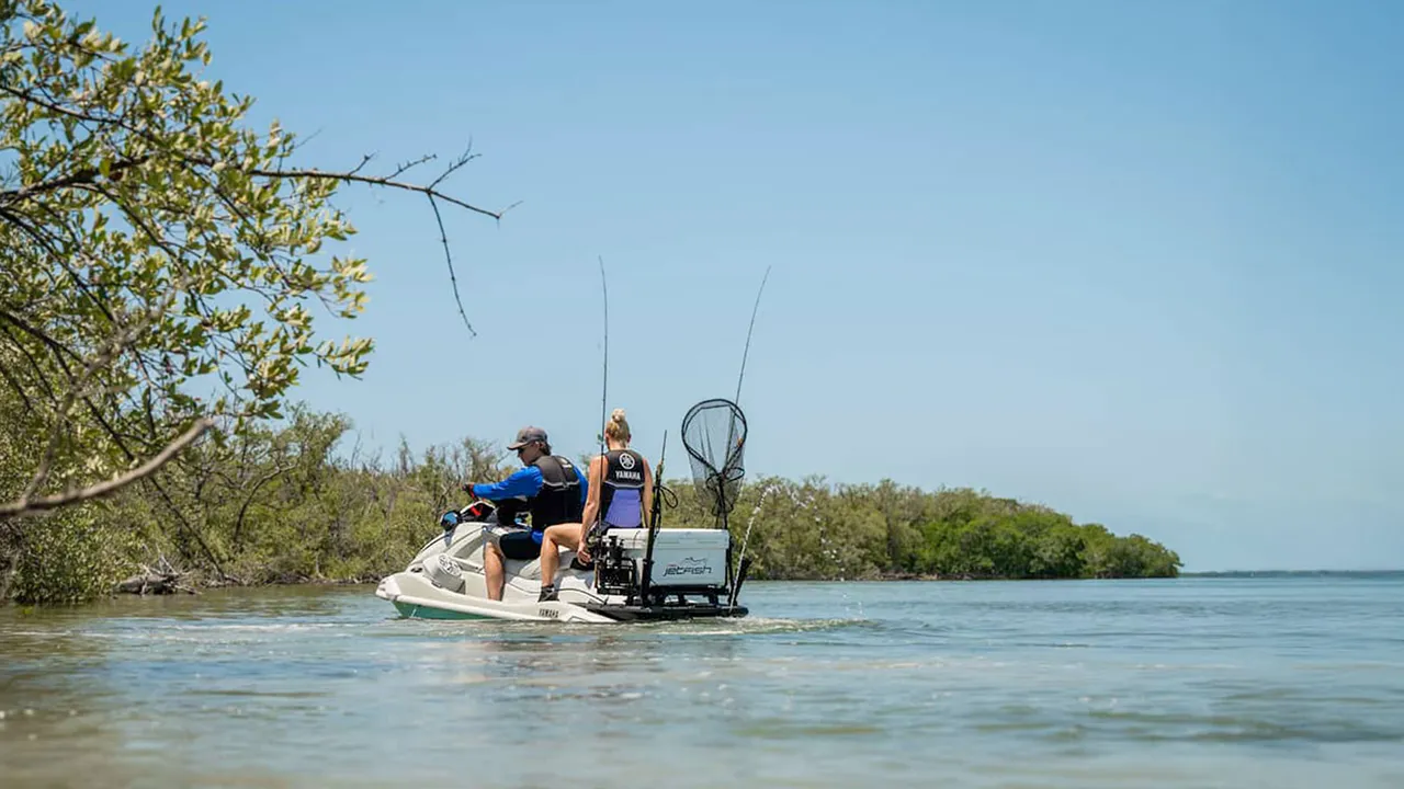Man and woman with fishing gear on a jet ski