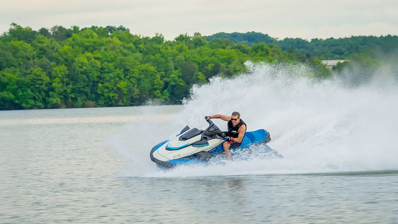 Man racing on a blue jet ski
