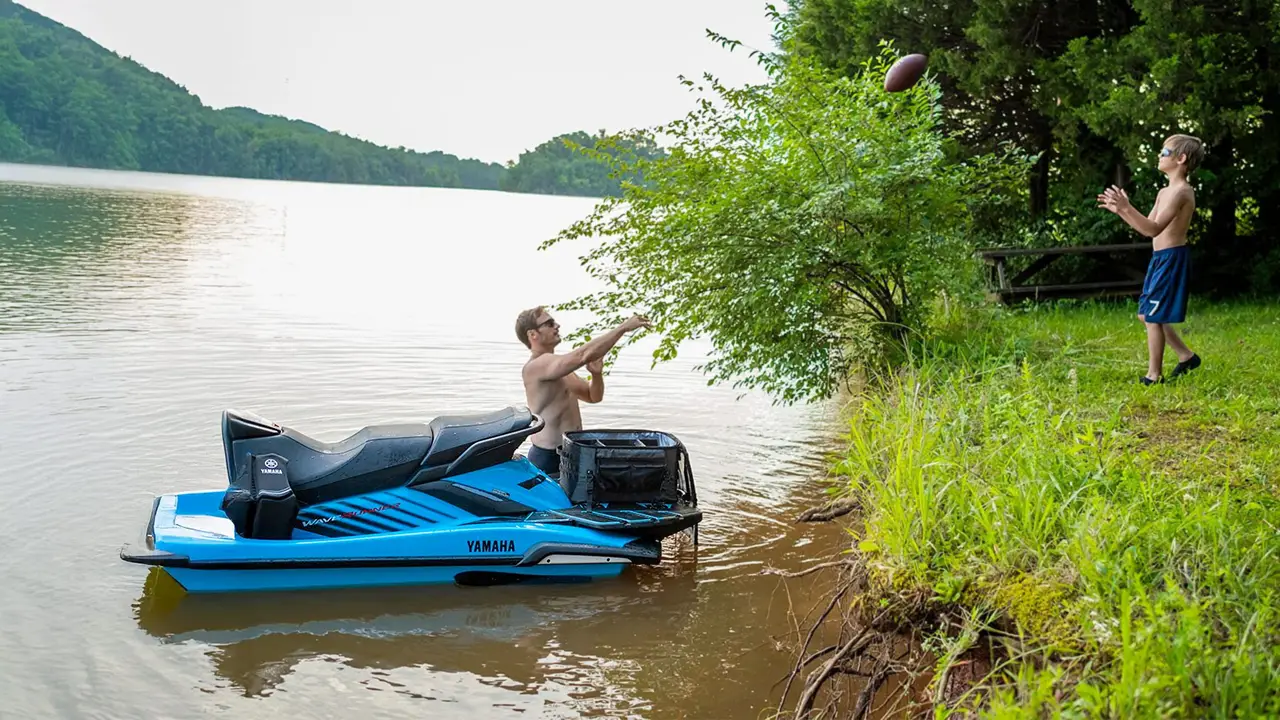 Stationery cyan jet ski on a river