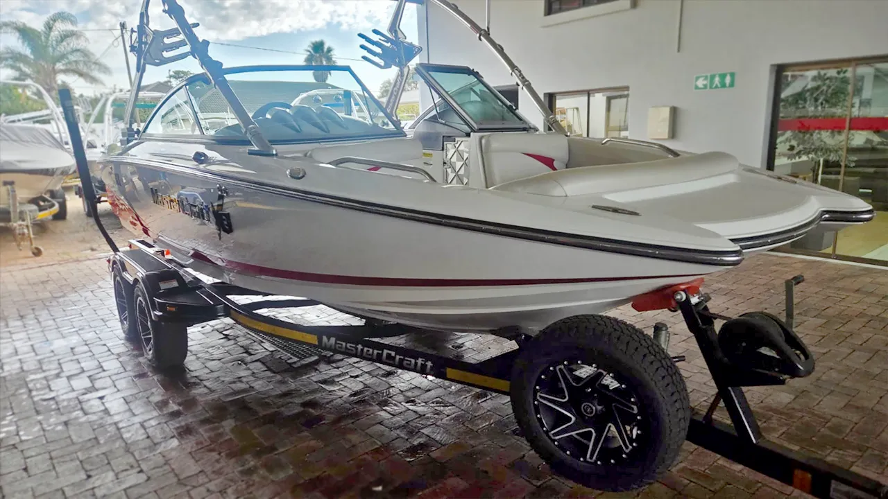 White and red boat on trailer